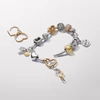 Kép 4/4 - Pandora 14k aranyozott barátság tripla függő charm - 763436C01